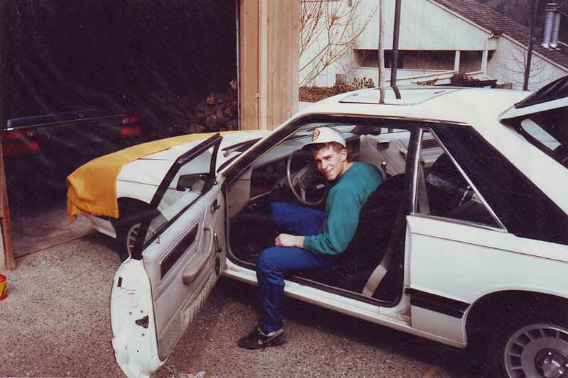 A young Chase Jarvis sits in the front seat of his car