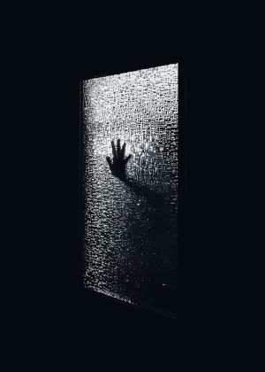 Hand on textured glass looking trapped