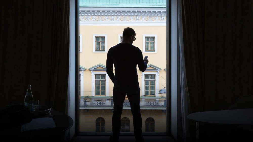 Chase Jarvis is silhouetted standing in front of a window